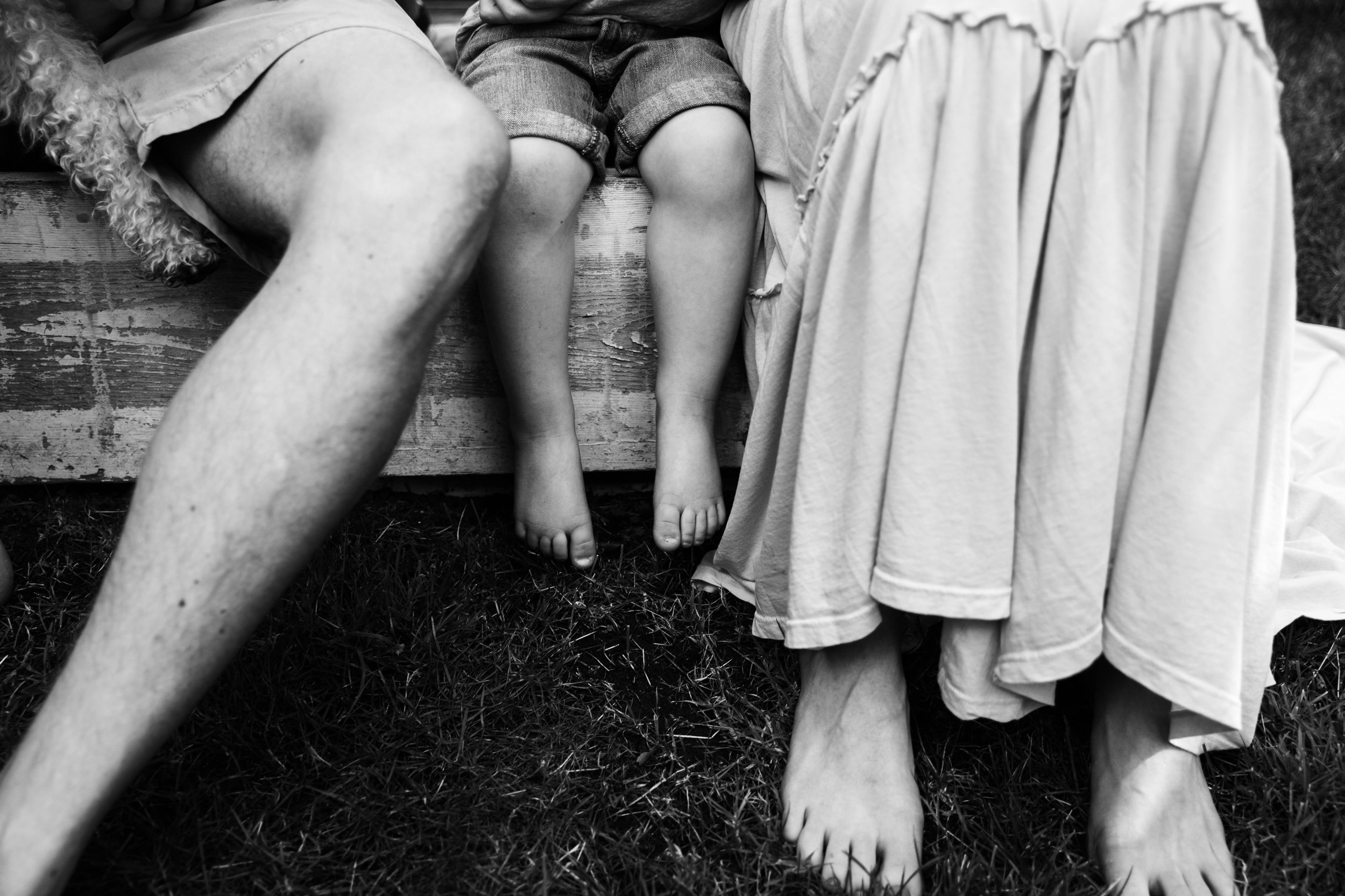 legs of family while sitting on a step