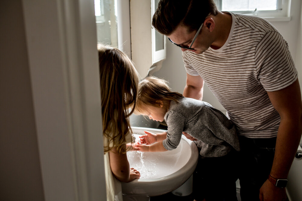  Kids washing their hands in the bathroom with dad 
