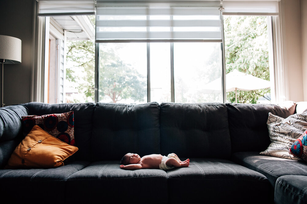 baby on couch alone by window