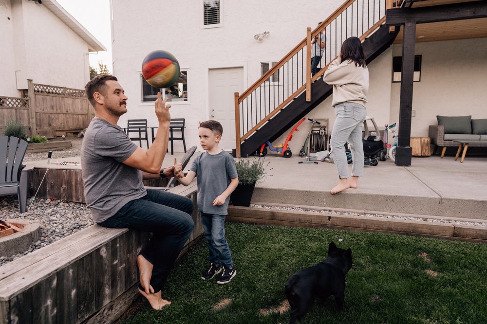 dad teaching son how to spin basketball on finger