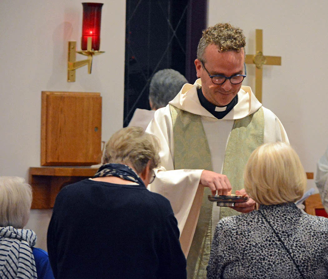 27 Andrew administering the Body of Christ.jpg