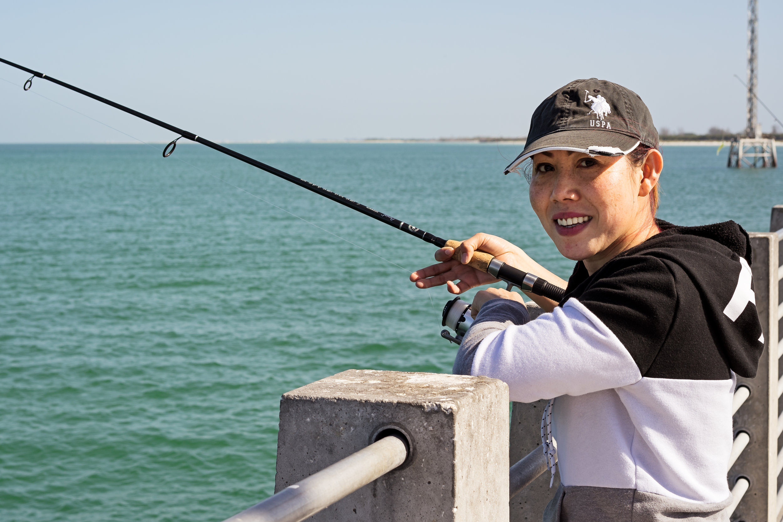 Lynn, one of the many female fishermen, fishing off the Gulf Pier. Her bubbly personality and energy were contagious. She not only caught fish but took fish other people did not want that day. Lynn stated the she just loved to eat fish!
