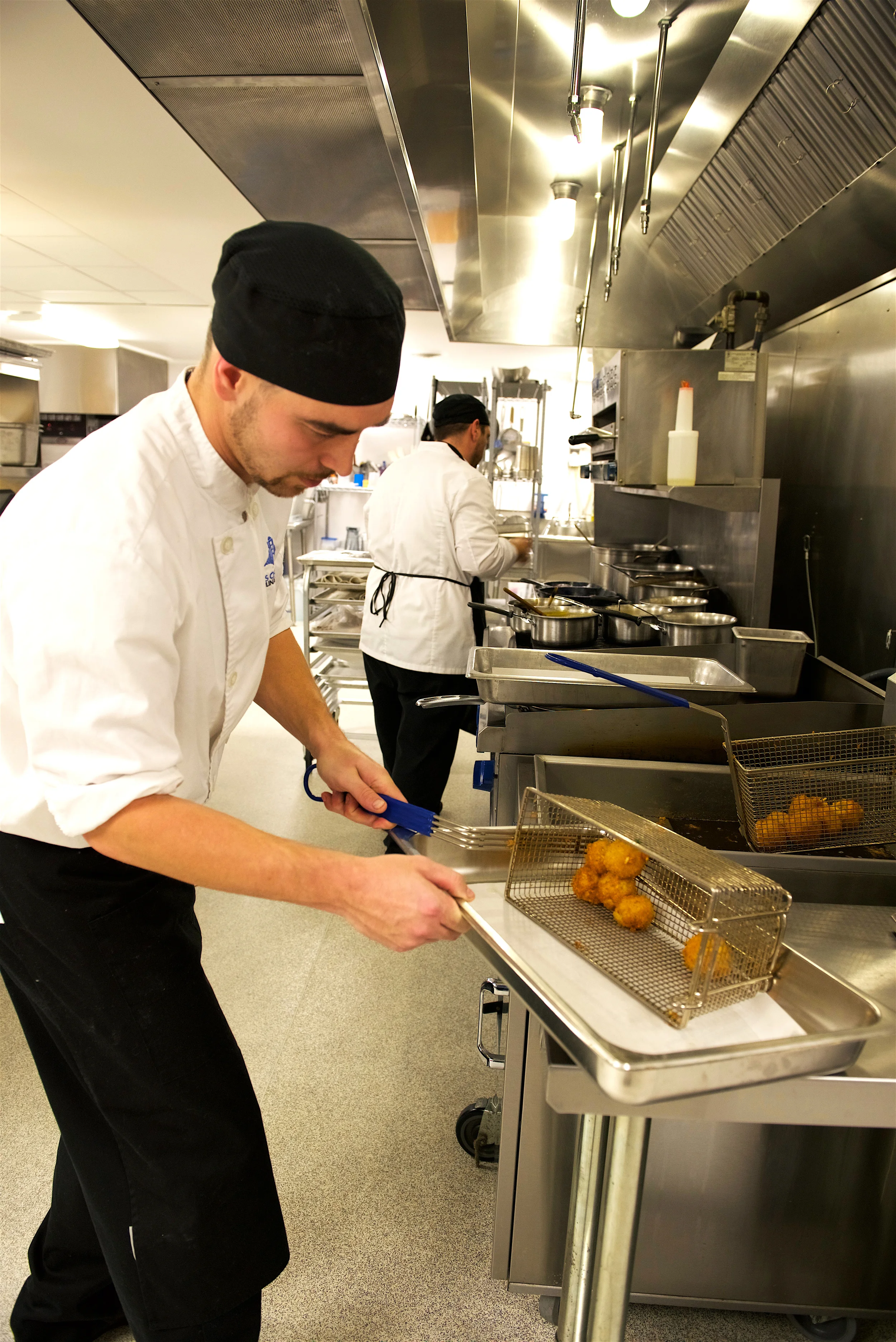 Student chef cooks his arancini for the Wild Game Dinner.