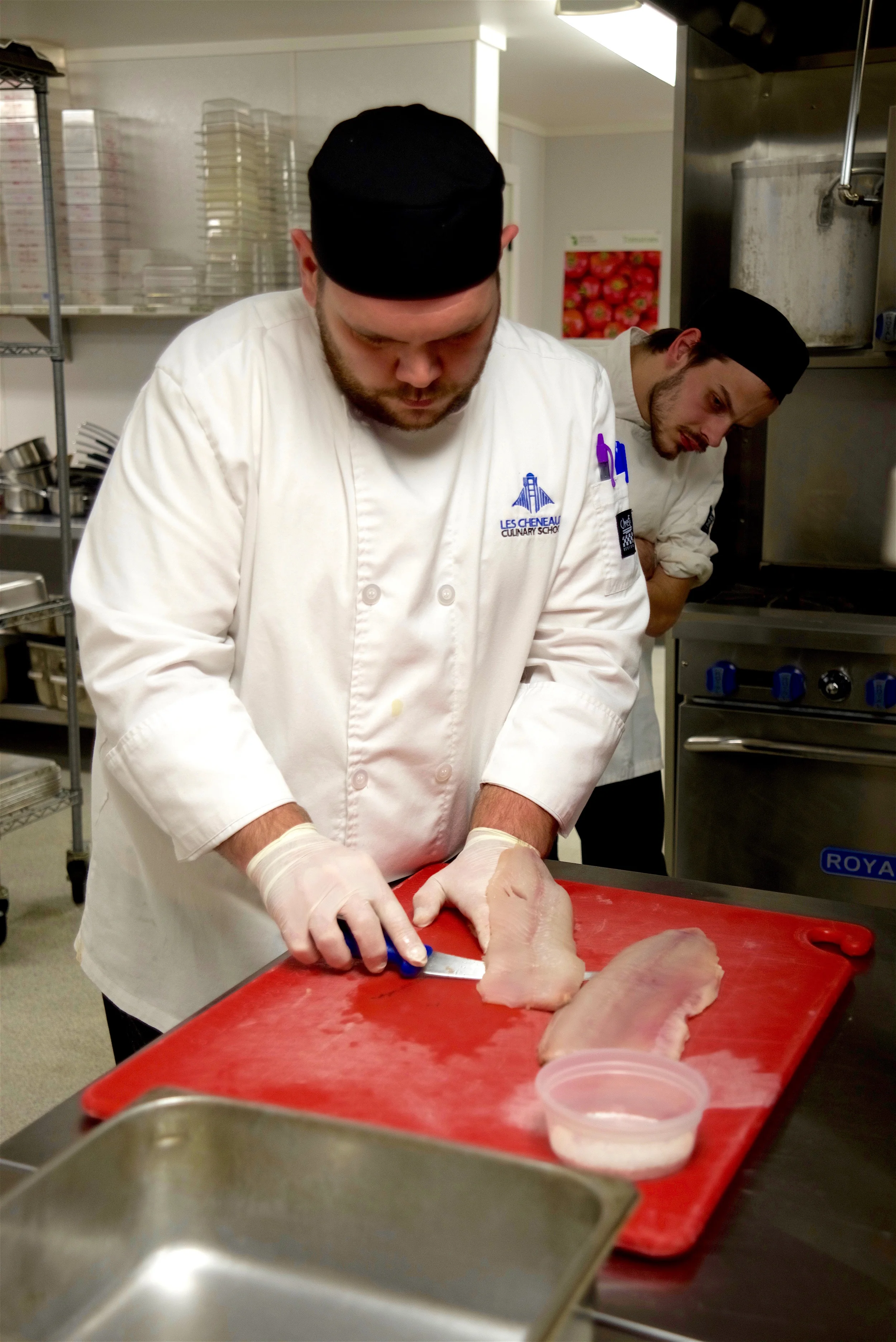 A student filets a local whitefish.