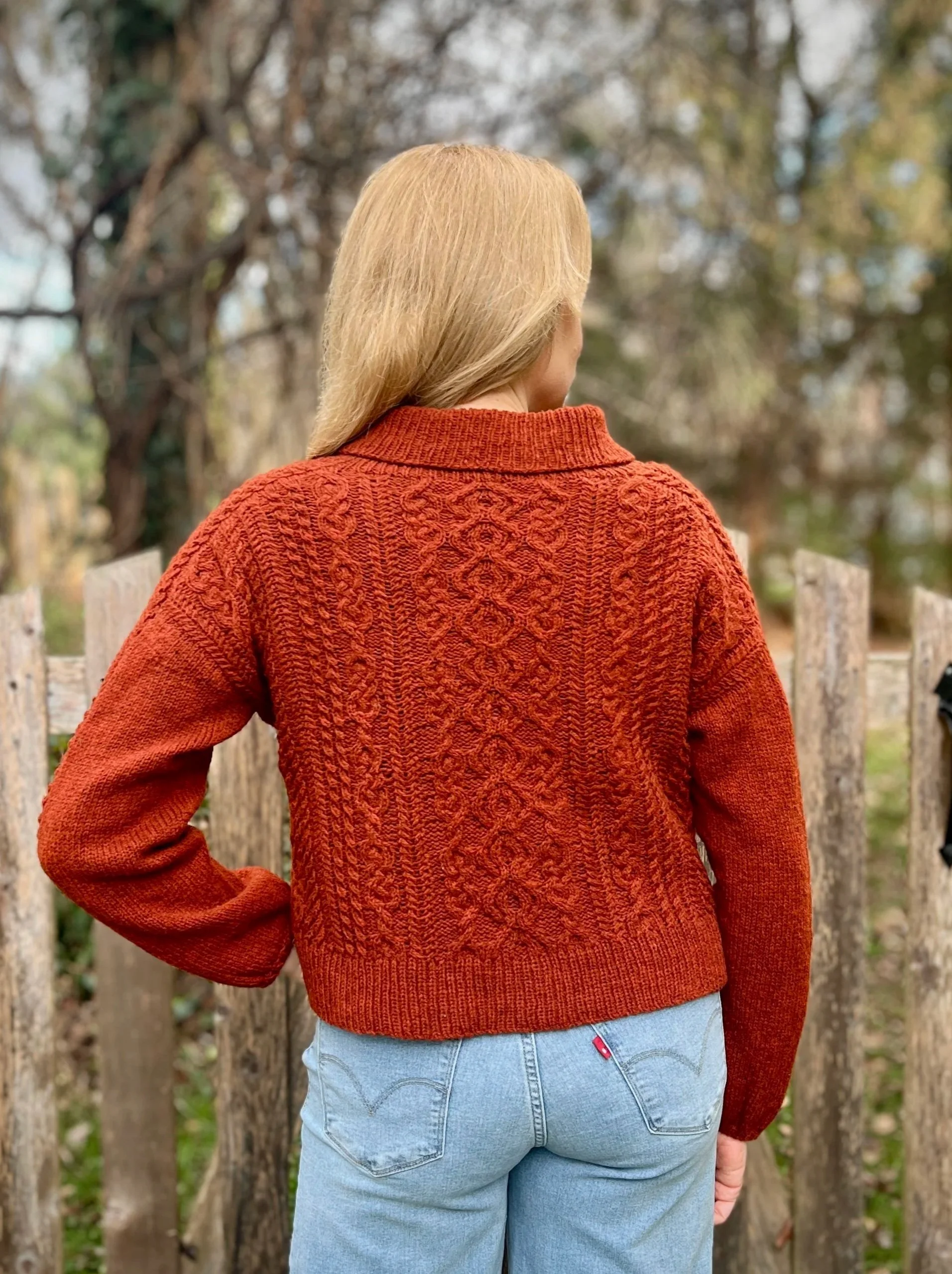 A heavily cabled saddle shoulder pullover