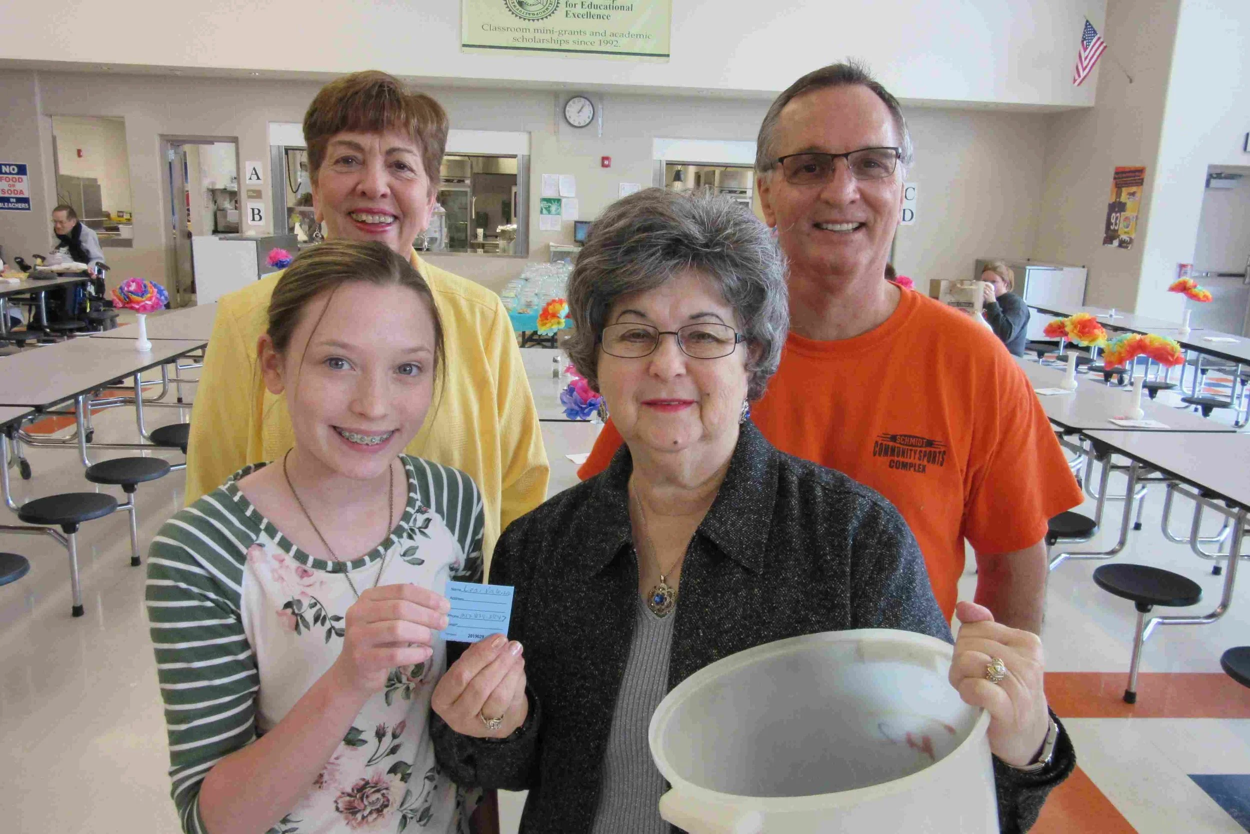 Shelbee Geisler and Rose Tebbe hold Lori Valerio’s winning ticket. Carole Scheller and Don Throne, both Partnership directors look on.