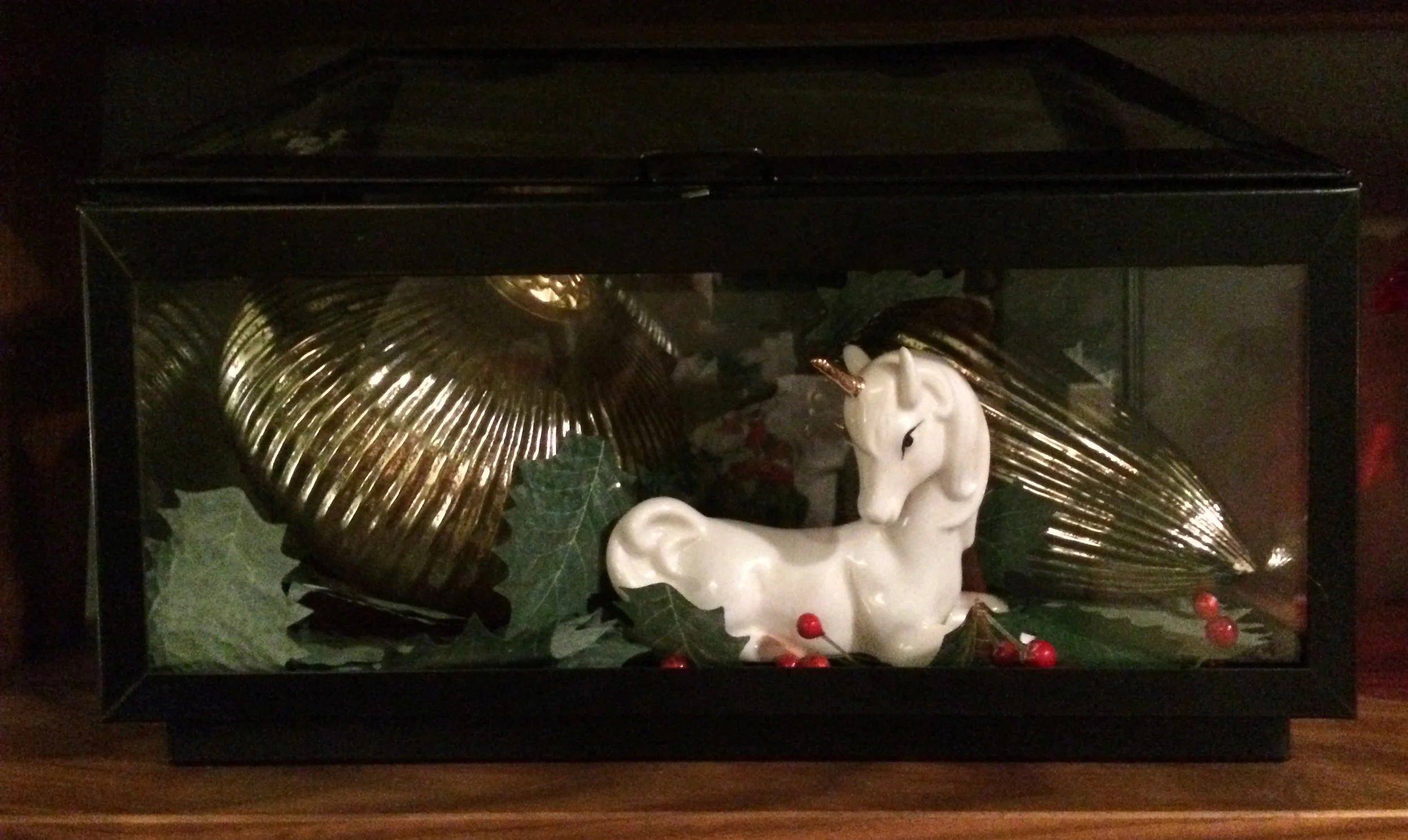Nothing says Merry Christmas like a unicorn trapped in a holly-filled terrarium