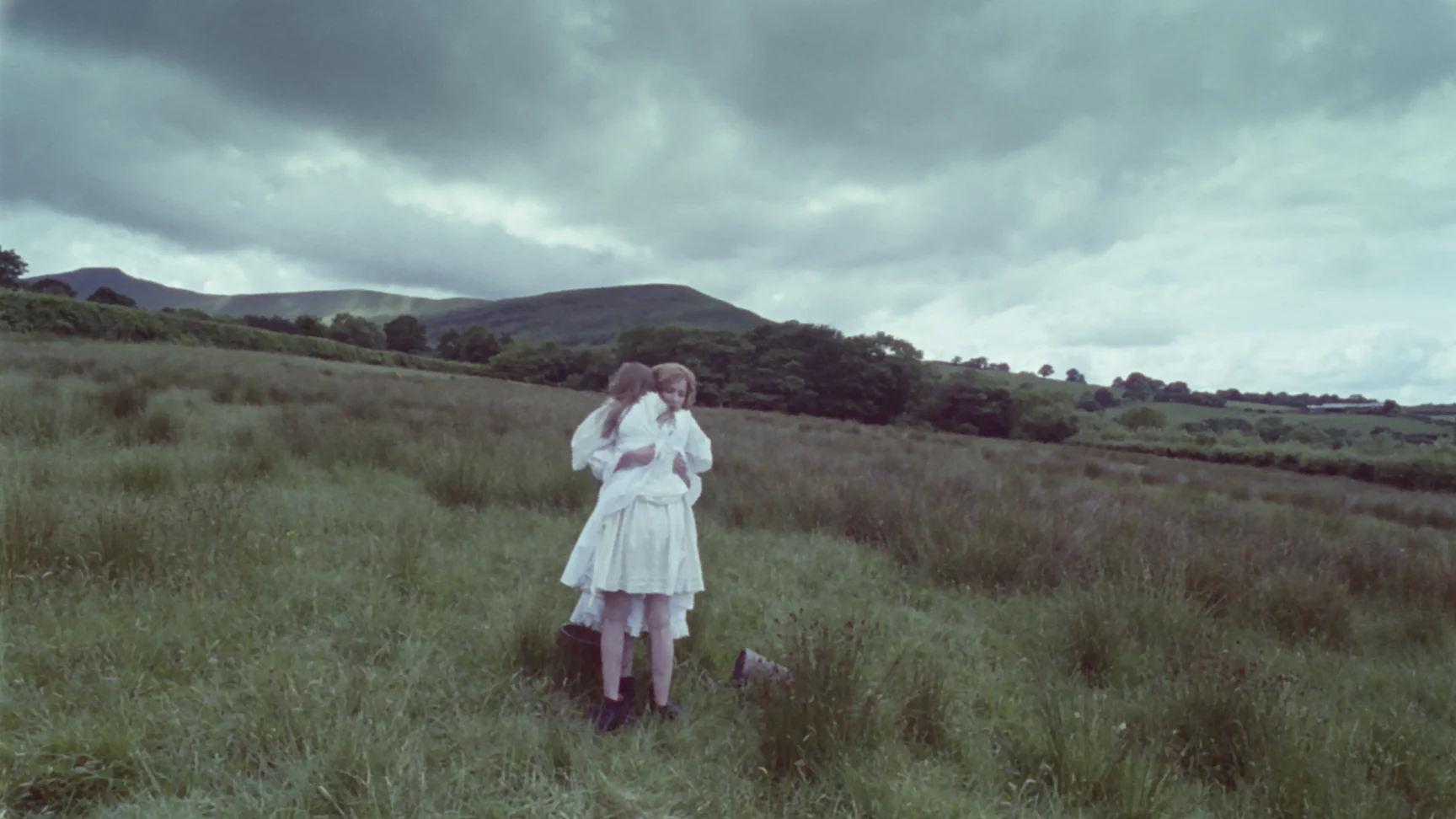 lizzie and laura hug in field.jpg