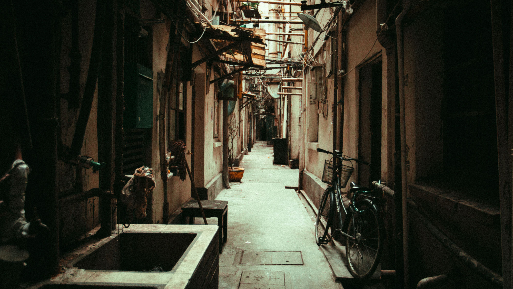 N arrow roads in a sprawling modern metropolis seamlessly morph into ancient alleys with shared sinks and laundry hanging to dry.