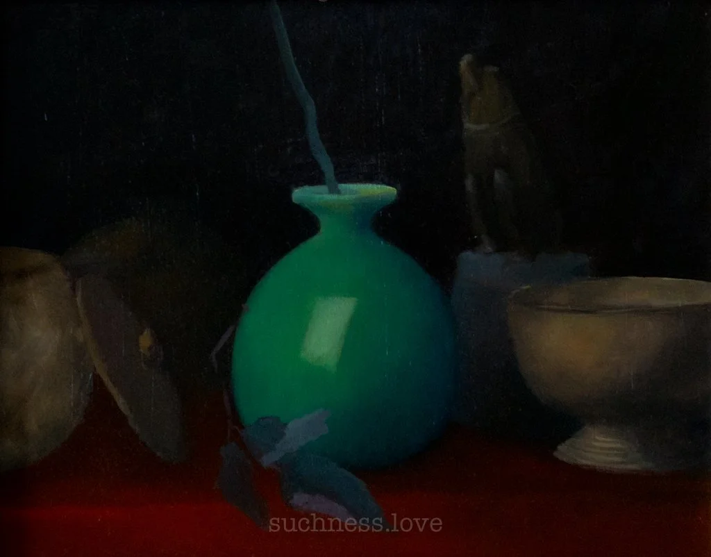 A glowing green vase with a blue design, surrounded by pottery, on a red surface in a dark setting.