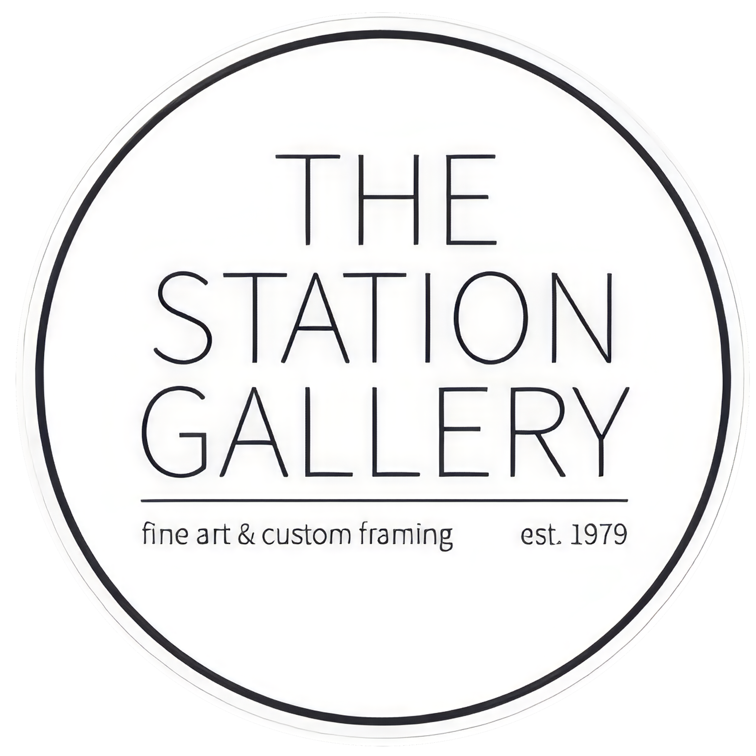 Close-up of a circular sign reading "The Station Gallery" with smaller text below indicating it is a fine art and custom framing establishment, established in 1979.