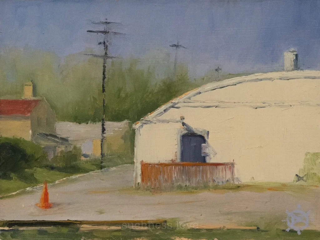 Painted depiction of a suburban scene with a curved white building, a black door, a wooden fence, a traffic cone, utility poles, and houses with trees in the background under a partly cloudy sky.