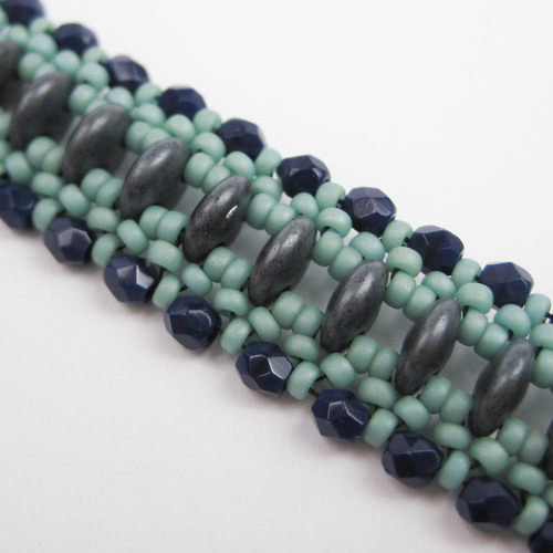 Just Rolling Along Pattern by Eileen barker, taught with permission. This simple and elegant bracelet uses Czechmate two-holed lentils to build a long pathway surrounded by seed bead picots and sparkling fire polish. Skill level Advanced Beginner. Cost $25.00 plus supplies.