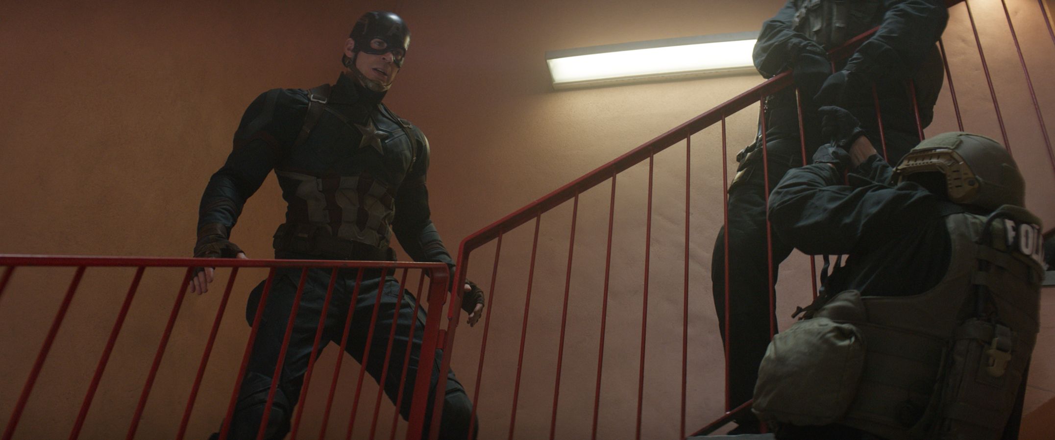 Captain America throwing police off stair cases to save Bucky, a wanted murderer.