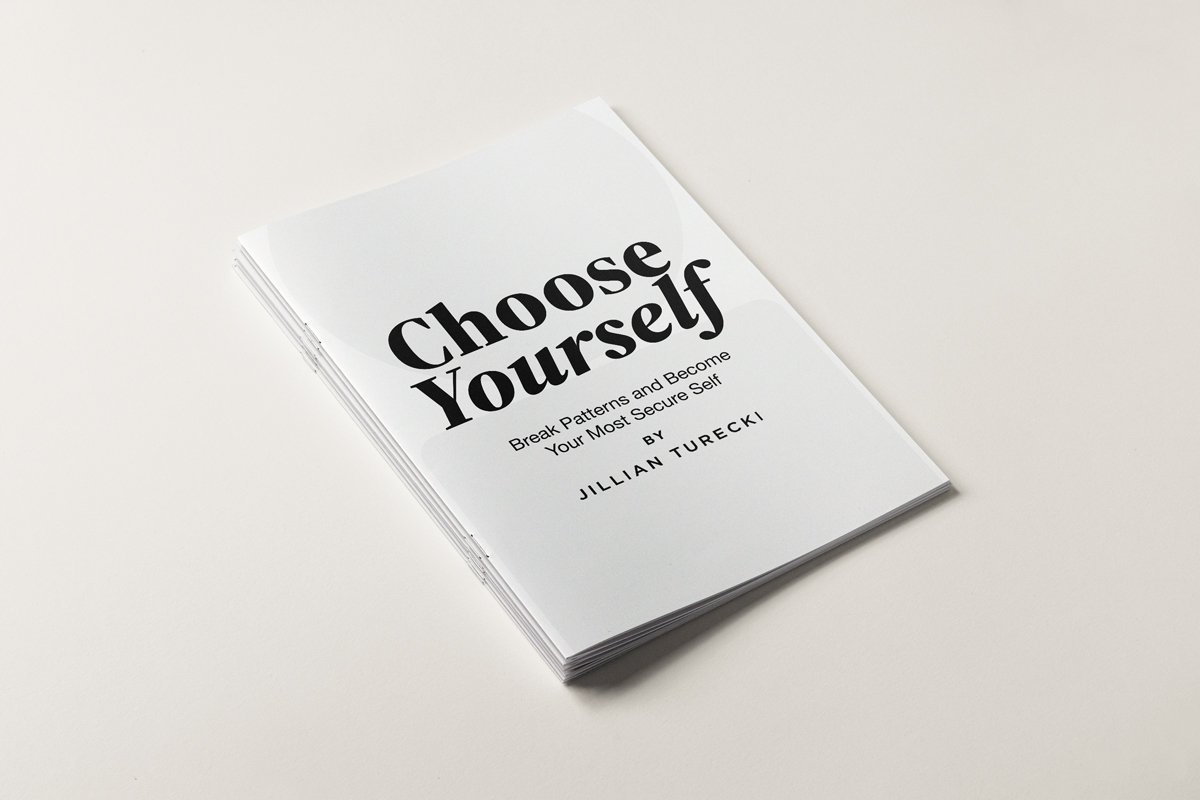 A white booklet titled "Choose Yourself" by Jillian Turecki with additional text "Break Patterns and Become Your Most Secure Self" on a plain, light-colored background.