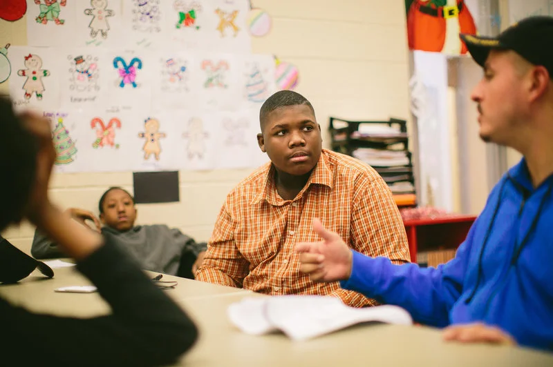 Jim Courtney-Clarks, 15, talks with Army veteran Alberto Bóleros during the Urban Warriors program in December. The Chicago program is designed to bring together veterans and youth who have been exposed to the city's violence. Alyssa Schukar for NPR