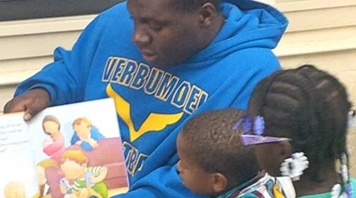 Photo of Urban Compass participant serving as mentors to young members of the community. Photo by Urban Compass .