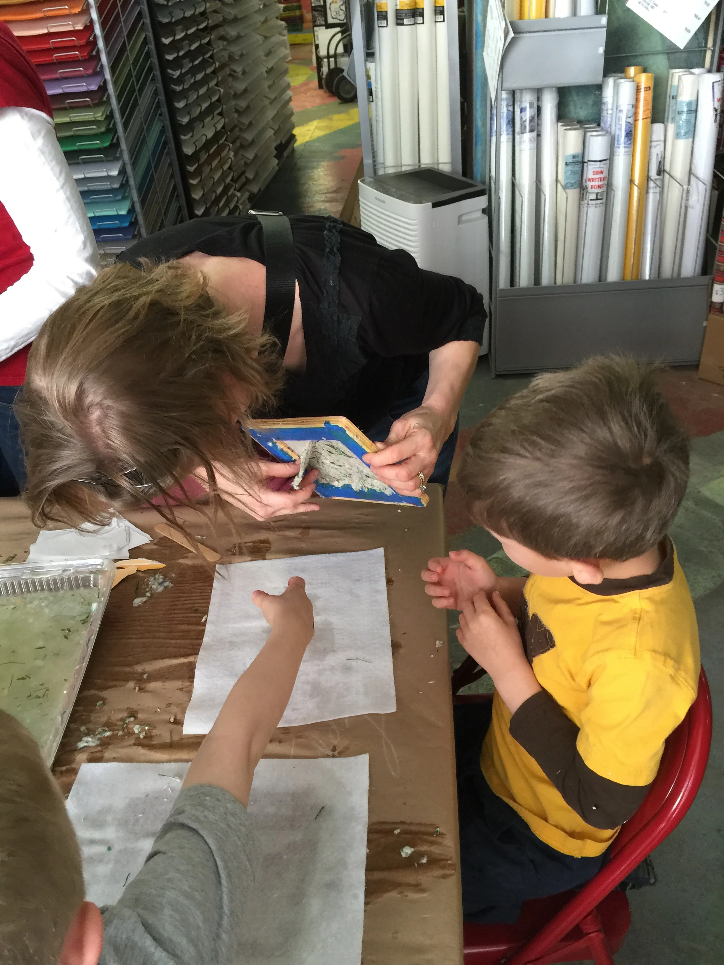 Team Teddy & Mommy carefully removing the paper from their frame.