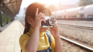 kid with camera art table studio.jpg