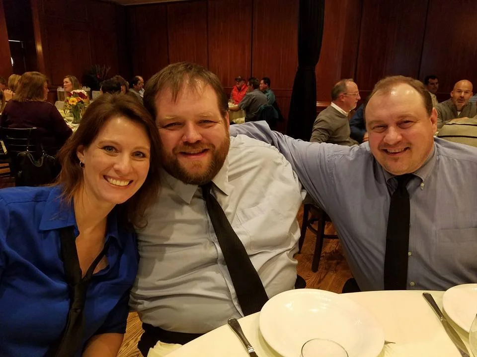 Angela Beckefeld, Dave Ebert, and Jim Bushy bond together at a benefit where they performed.