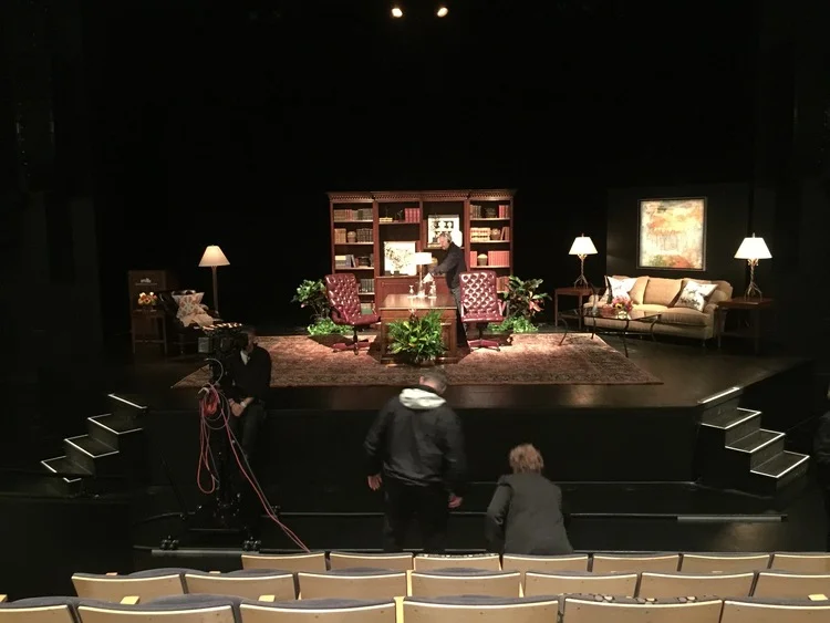 We entered the theater as the stage was still being prepared for the interview.  The library-themed set was designed and provided by Bittner's.