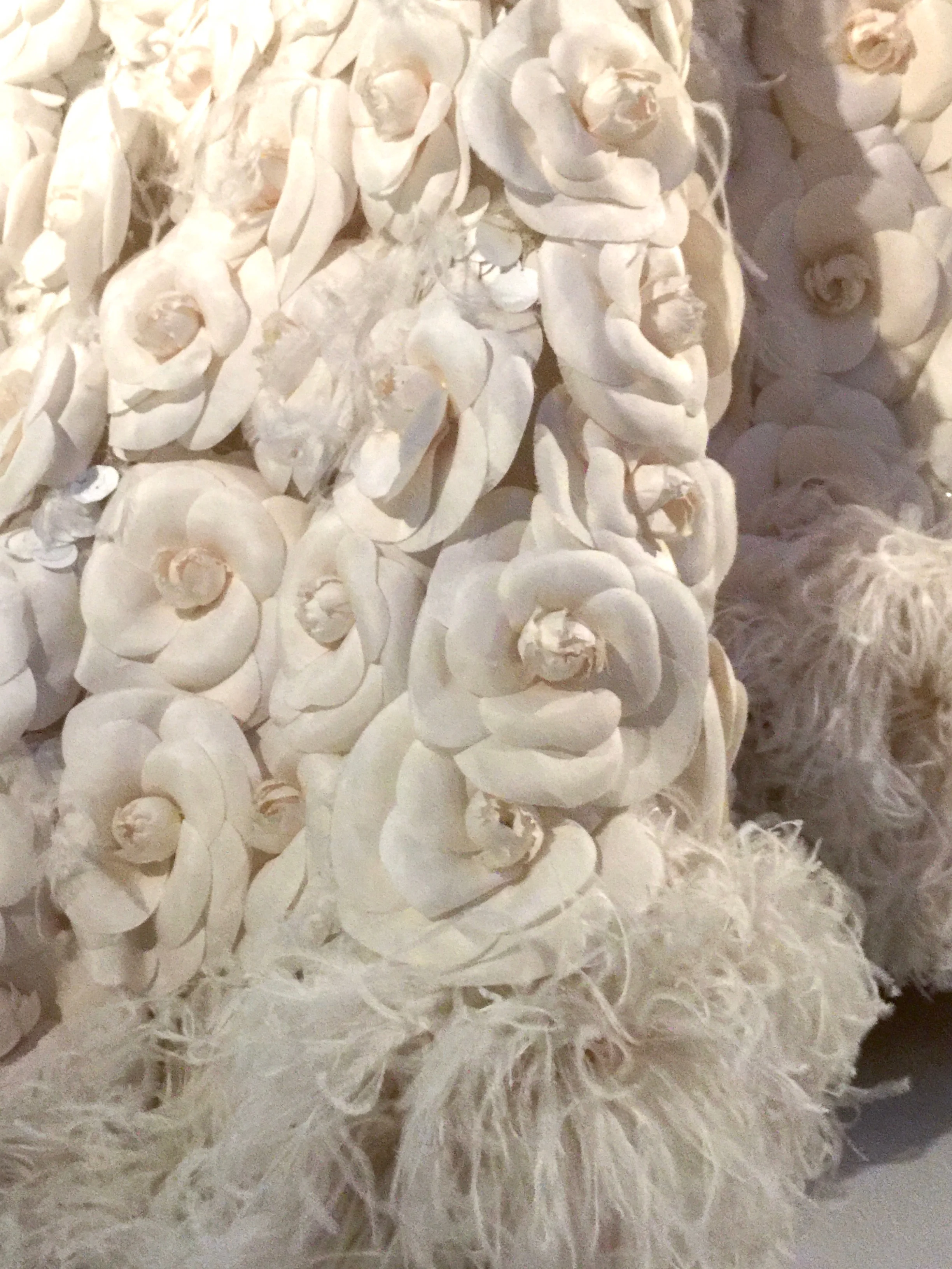 Detail shot of the camellias- CHANEL's signature flower.  Each flower takes up to ninety minutes to complete.  It took twenty-five hundred of these white flowers to embellish this couture dress.
