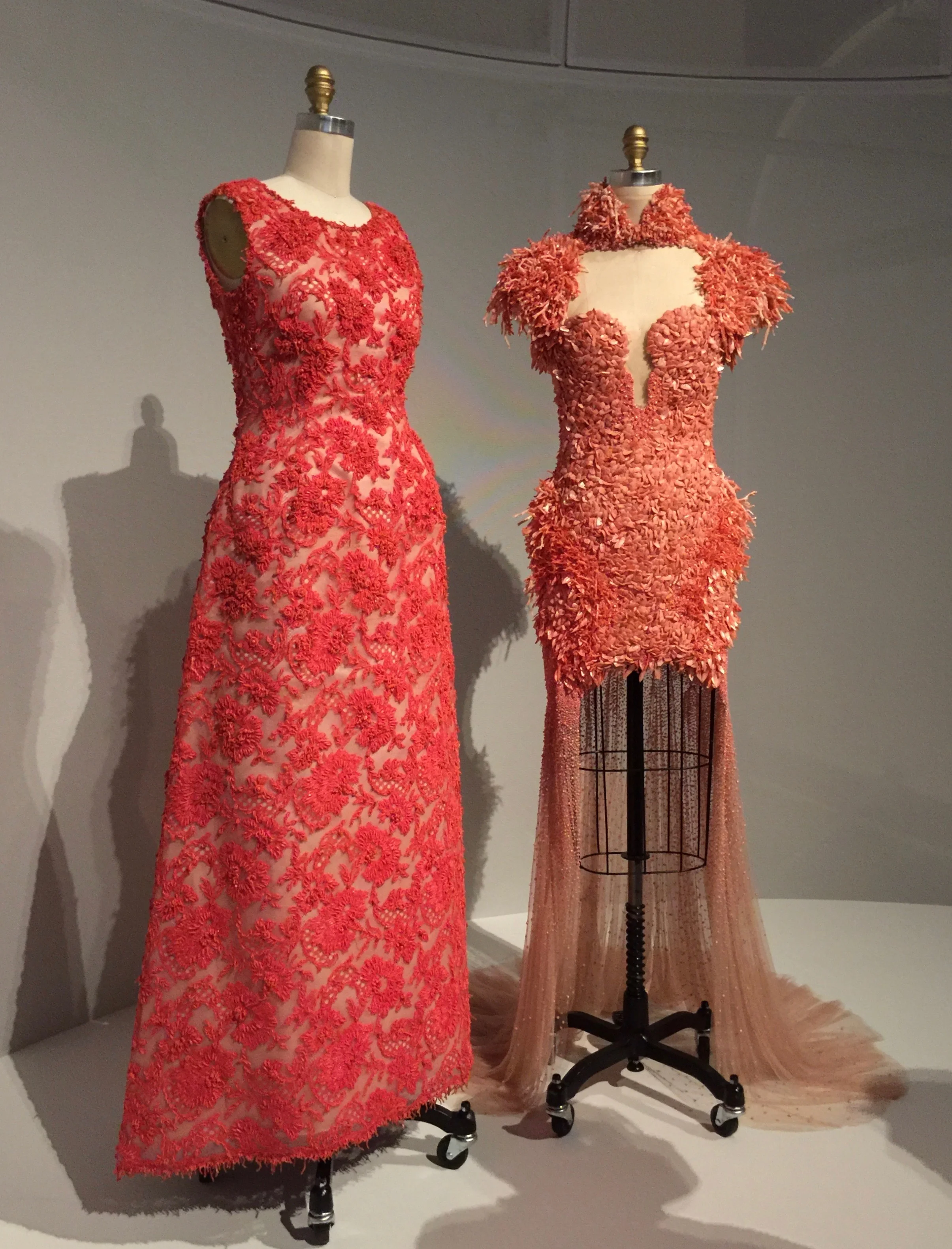 (l) HOUSE OF GIVENCHY, Hubert de Givenchy DRESS, 1963, haute couture Hand-sewn red-orange cotton Mechlin-type lace hand-embroidered with red-orange glass beads, tinsel, and pieces of coral (r) ALEXANDER MCQUEEN, Sarah Burton DRESS, Spring/Summer 2012, pret-a-porter