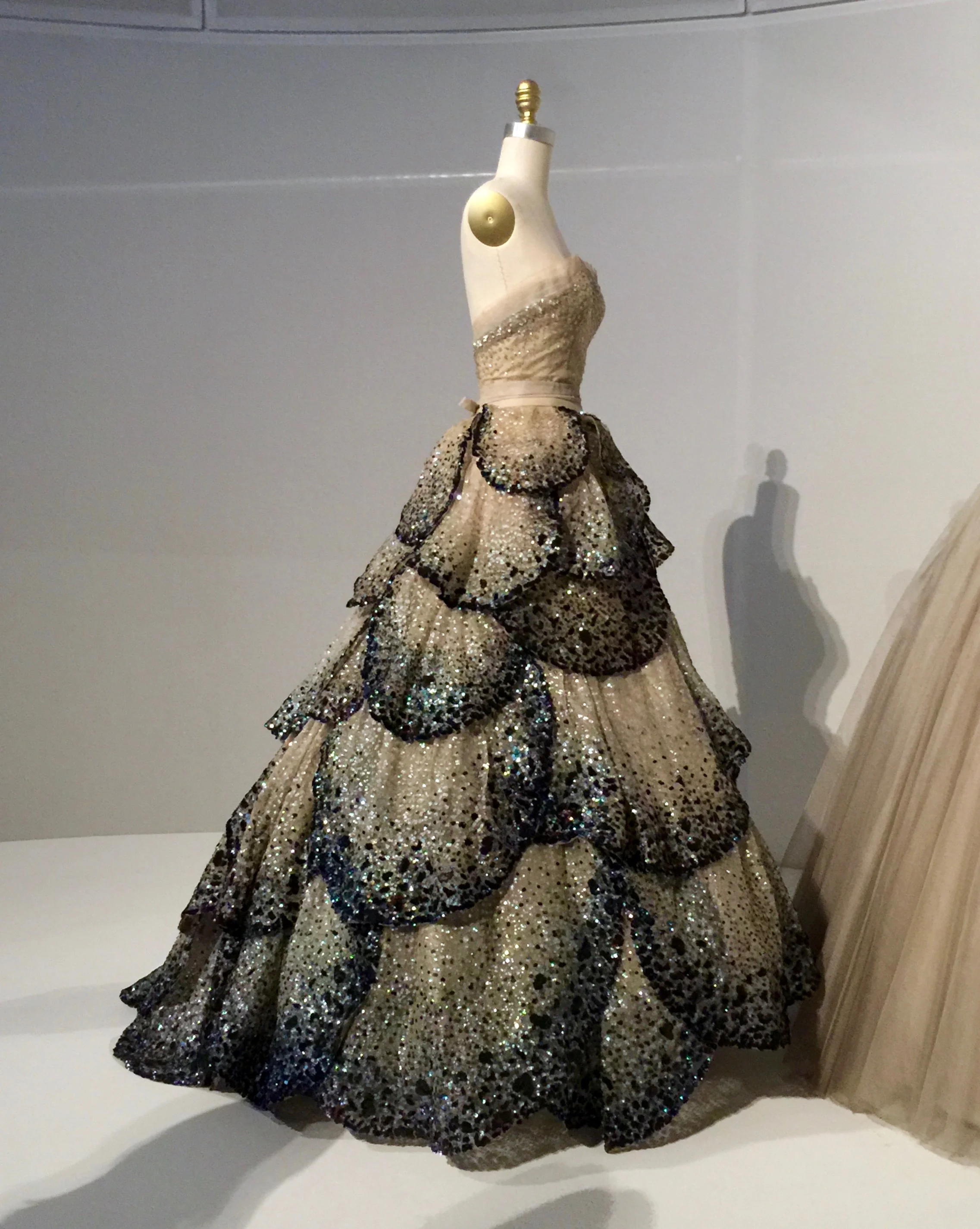 HOUSE OF DIOR, Christian Dior "JUNON" DRESS, Autumn/Winter 1949-50, haute couture Machine-sewn, hand-finished pale green silk faille and taffeta foundation, hand-sewn pale blue silk tulle embroidered with opalescent sequins, hand-appliqué of forty-five hand-cut pale blue silk tulle and horsehair petals, hand-embroidered with opalescent, blue, green, and orange gelatin sequins.