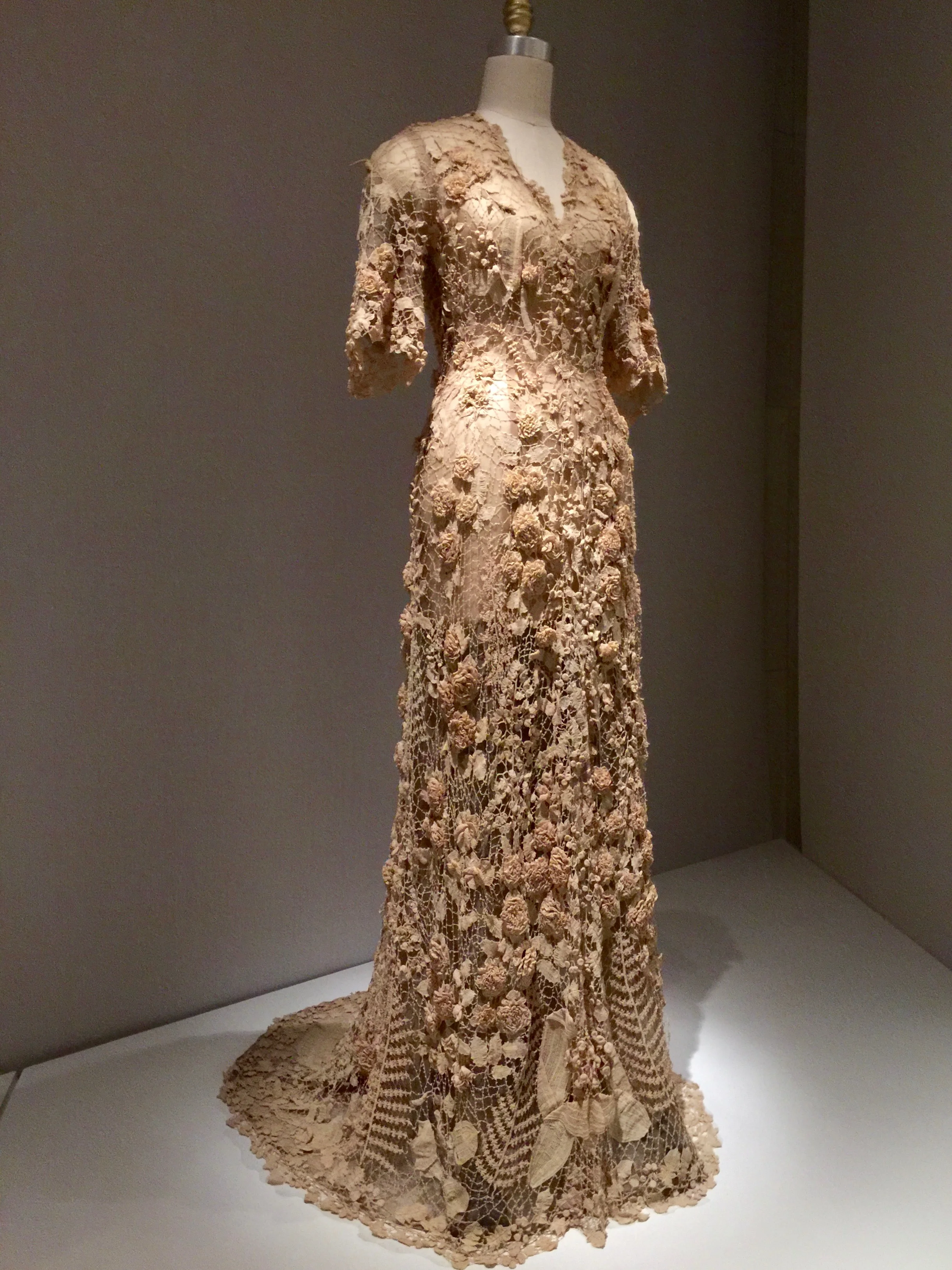 Irish WEDDING DRESS, Ca. 1870Hand-crocheted cream cotton lace with three-dimensional motifs, including roses, lilies of the valley, hanging fuchsias, morning glories, buds and berries, and flat and folded leaves and ferns