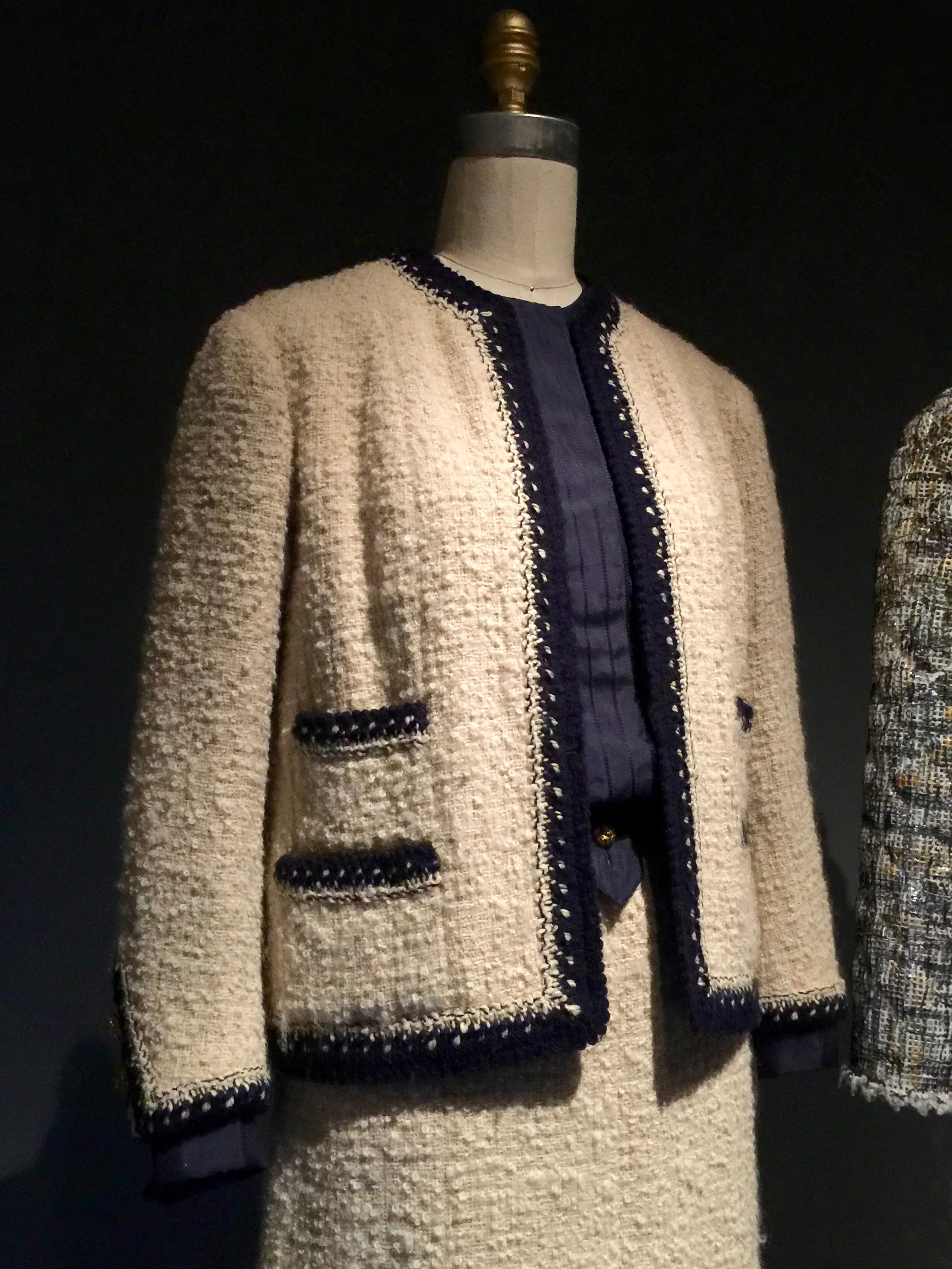 Machine-sewn ivory wool bouclé tweed, hand-applied navy and ivory wool knit trim hand-braided with interlocking chain stitch