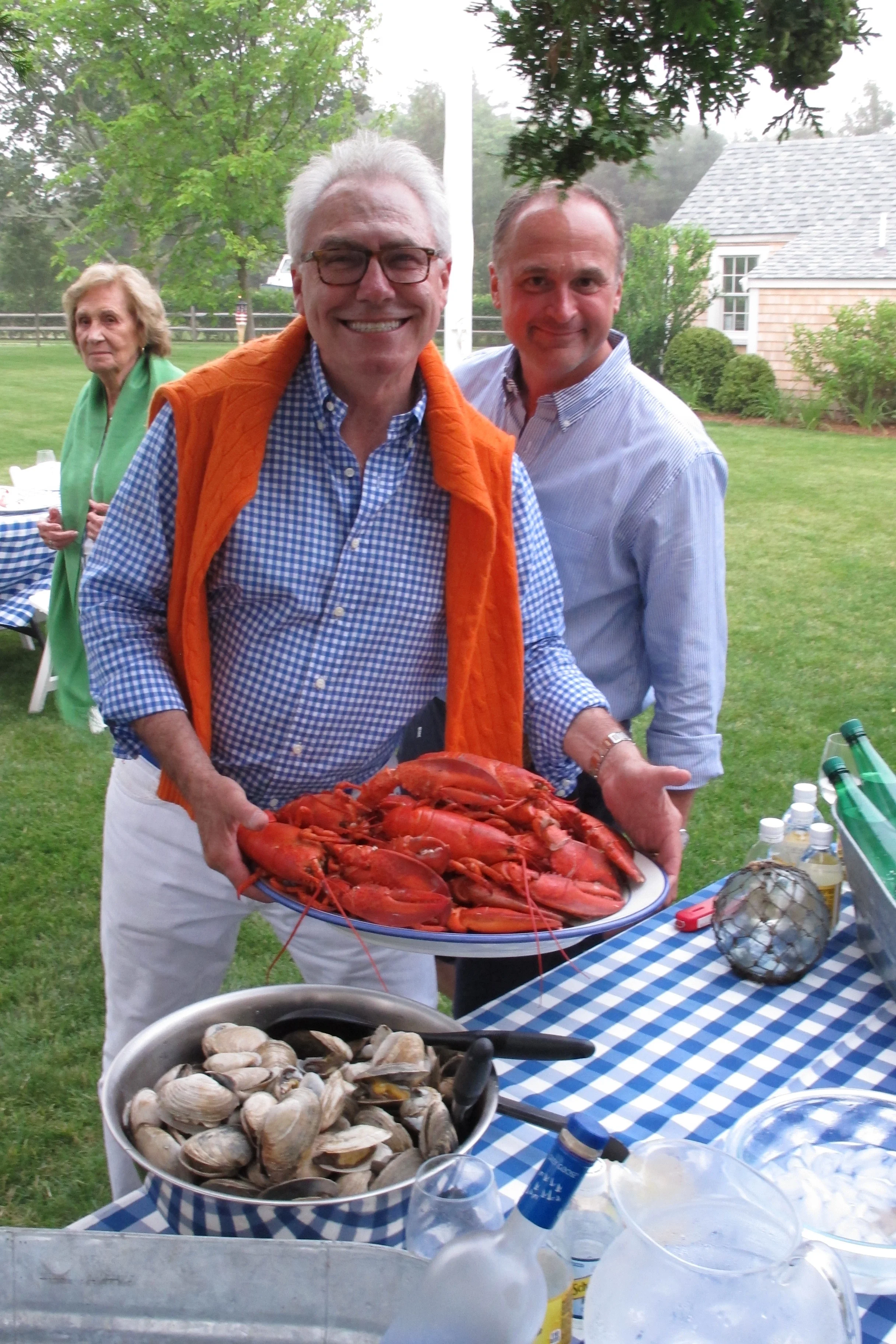 Gary holding a platter of freshly cooked lobsters.