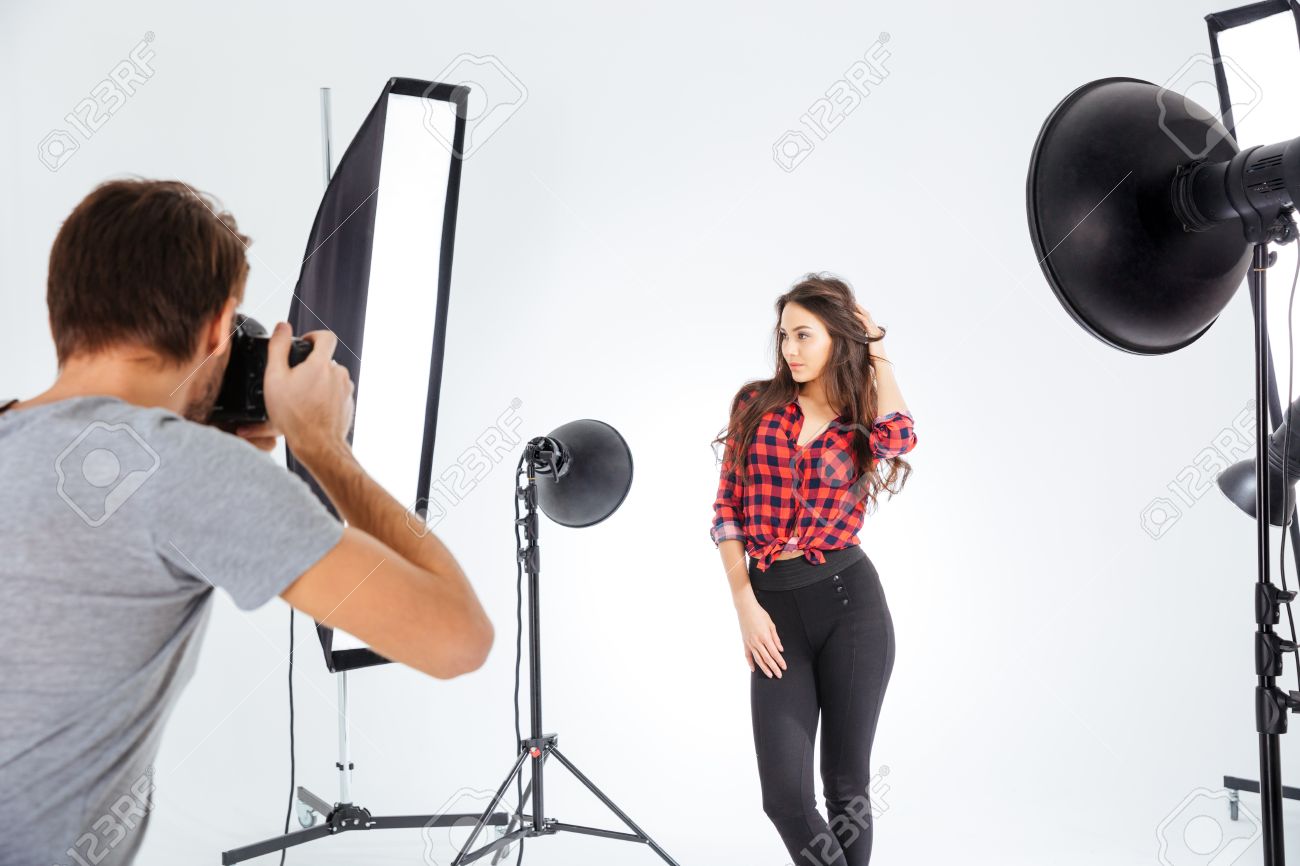 Photographer shooting model in studio