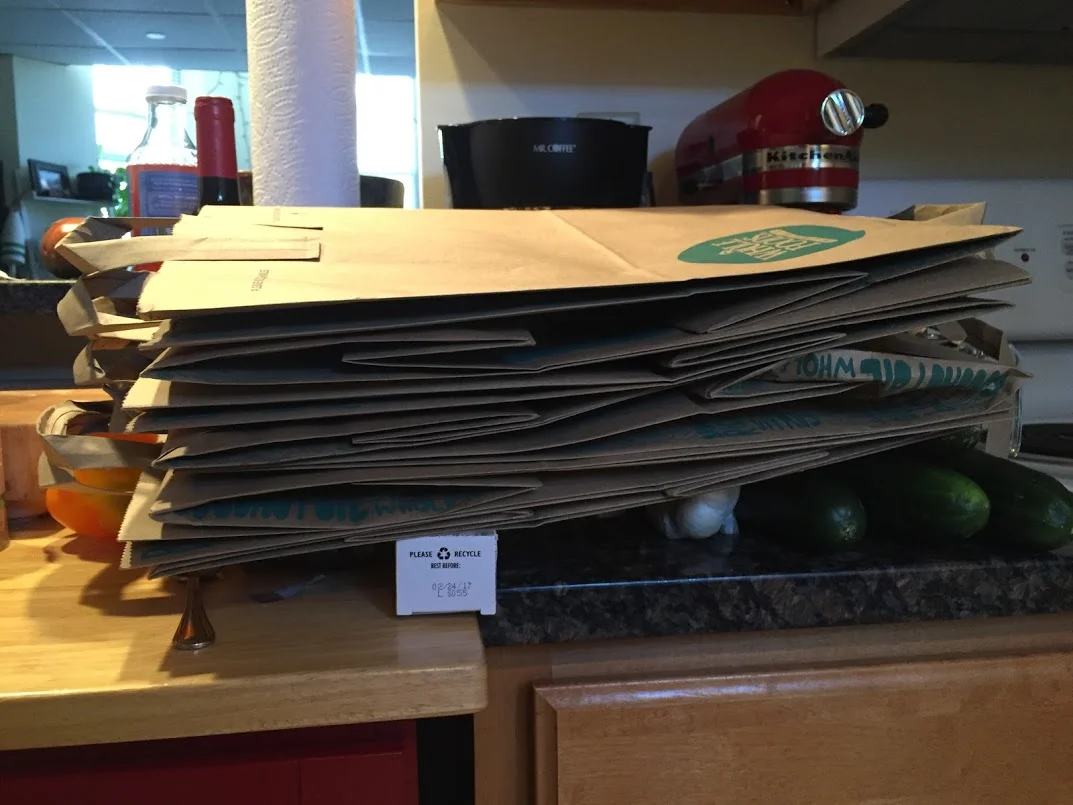 Glorious paper bags. Look closely and you will see a reusable, refillable, bottle of organic kombucha in the background.