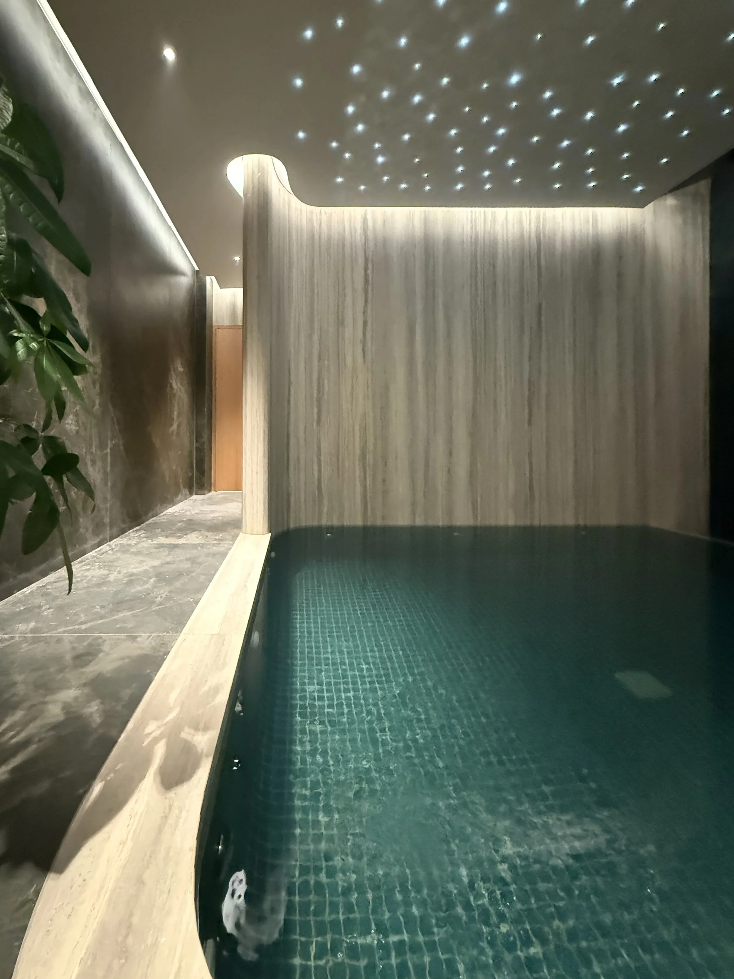 Tulah wellness clinic interior design - indoor spa pool with star ceiling and stone tiled walls