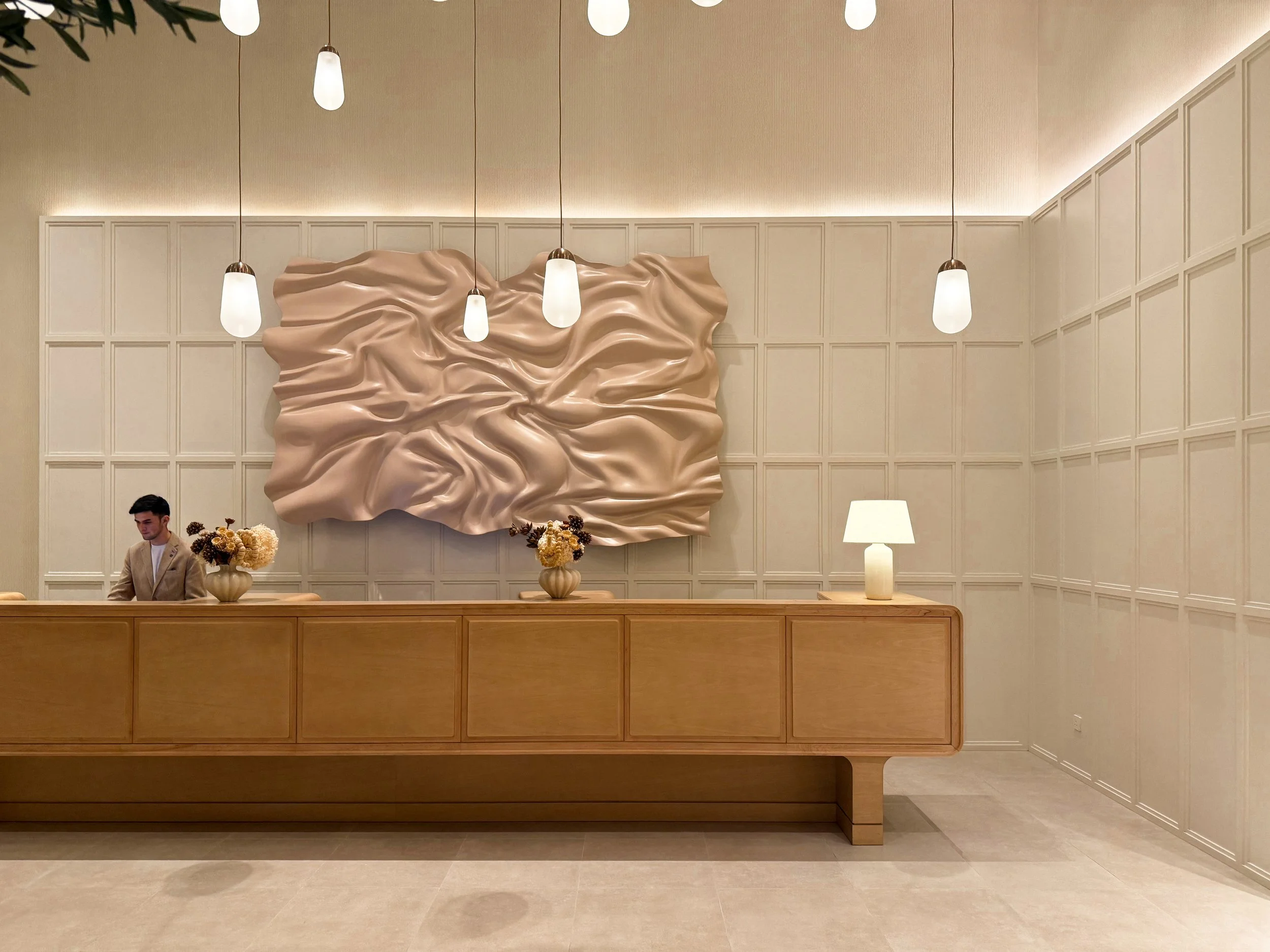 Vida Dubai Mall – Interior Design – hotel lobby with metallic wall sculpture and pendant lighting – Studio KKD