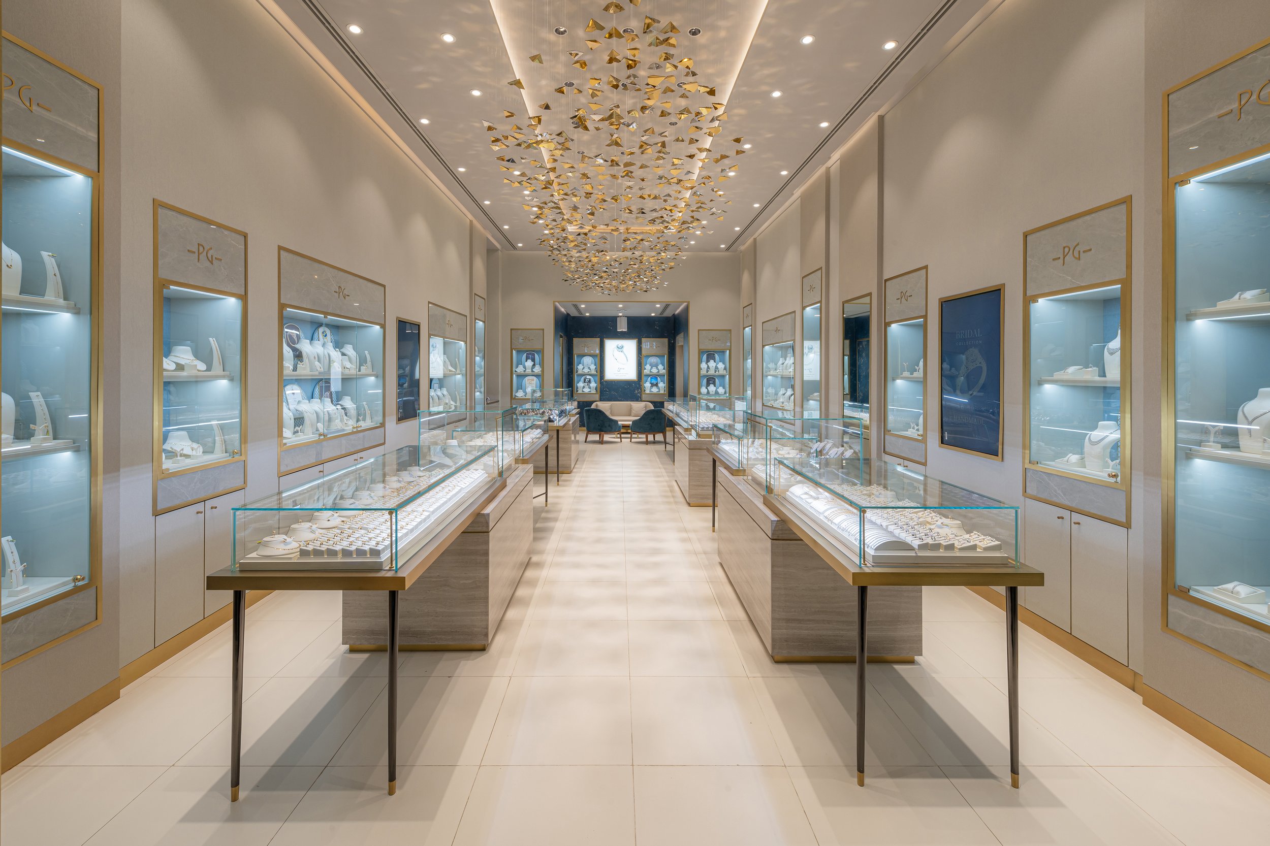Pure Gold Jewellers retail interior design - full-length store view with gold geometric chandelier