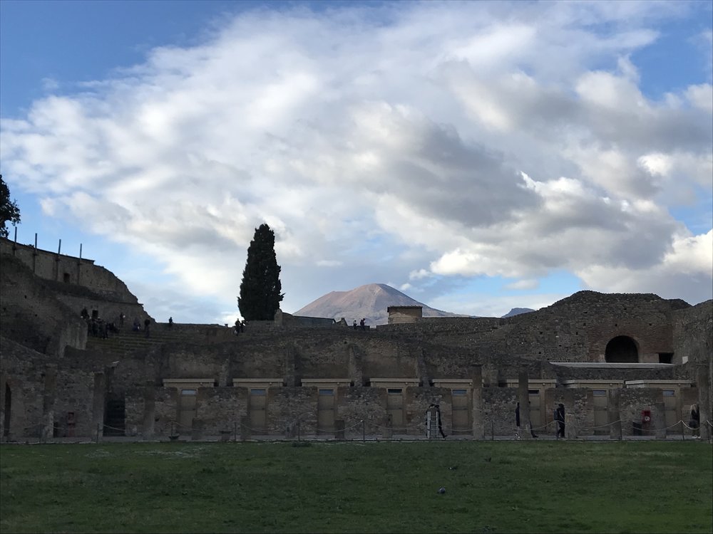  Vesuvius looming large in the distance. The weather was brisk, but this meant there were fewer visitors. This helped me imagine what the city must have looked like centuries ago, before tourists bearing iPhones flowed in. And I’m hearing the lyrics 