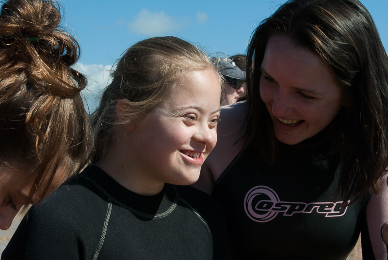 Young surfing girl with Down Syndrome