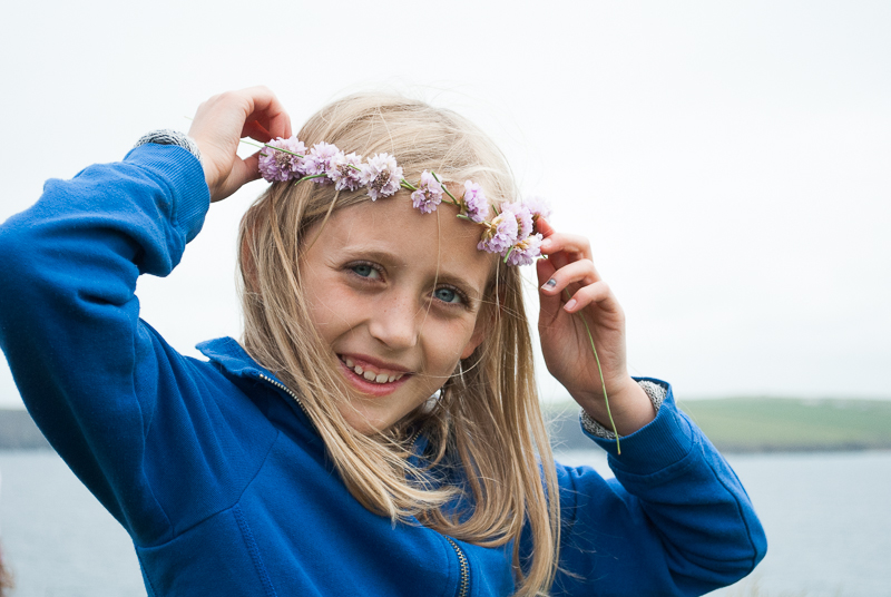 Pretty crown of coastal flowers on young girl