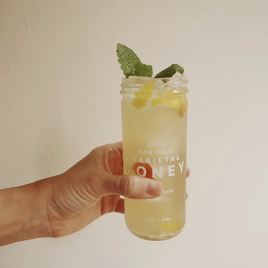 Orange blossom lemonade. Quarter 1/2 lemon + 1 quarter small mandarin. Add 1 to 2 tbls honey syrup. Muddle. Add 1 healthy sprig of spearmint. Muddle. Add 1/2 tbs of orange blossom water. Stir. Top with soda water and 1/2 tbs of Morris Ginger syrup. Sprig of mint + zest of lemon and mandarin, optional. Serve over ice.
