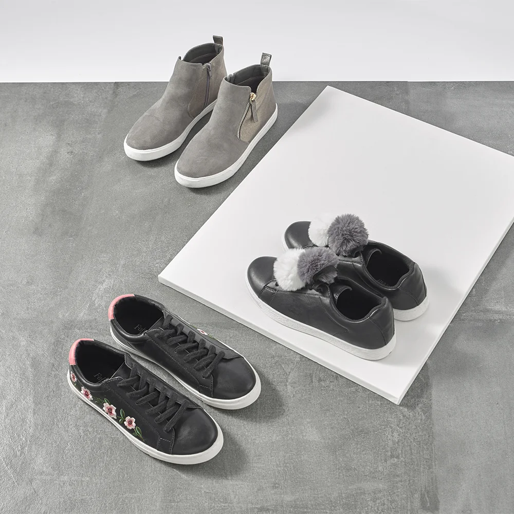 fashion flats, kids shoes shot overhead on concrete and white tile background. Still life fashion photography shot in london studio