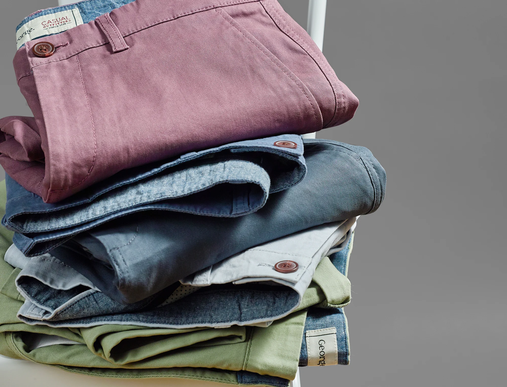 Fashion stacks, a pile of jeans on a stool make up this creative still life product photograph from Howlett photography