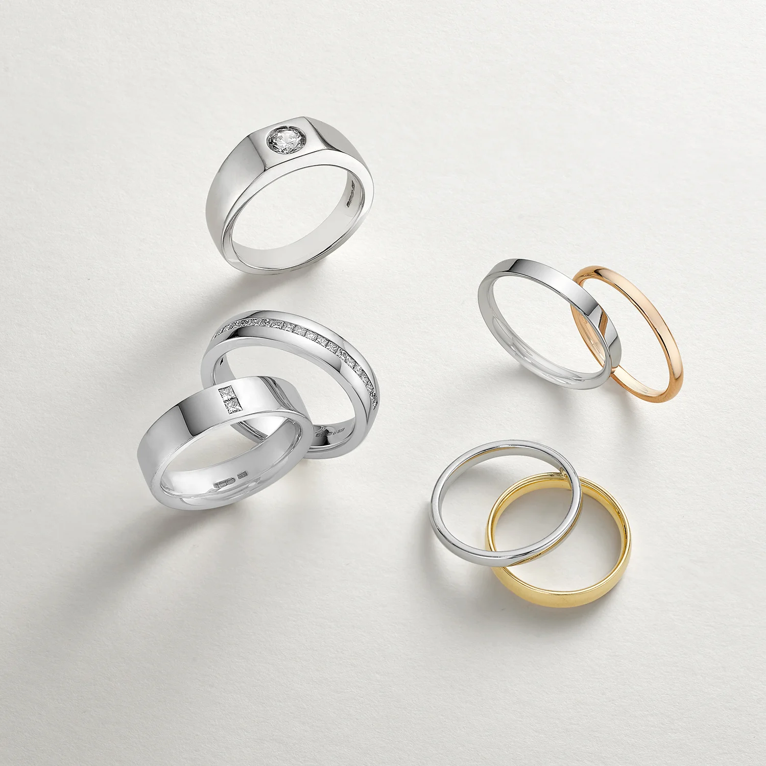 London ring shot on grey soft background paper. gold and silver luxury items arranged in creative stylised way.