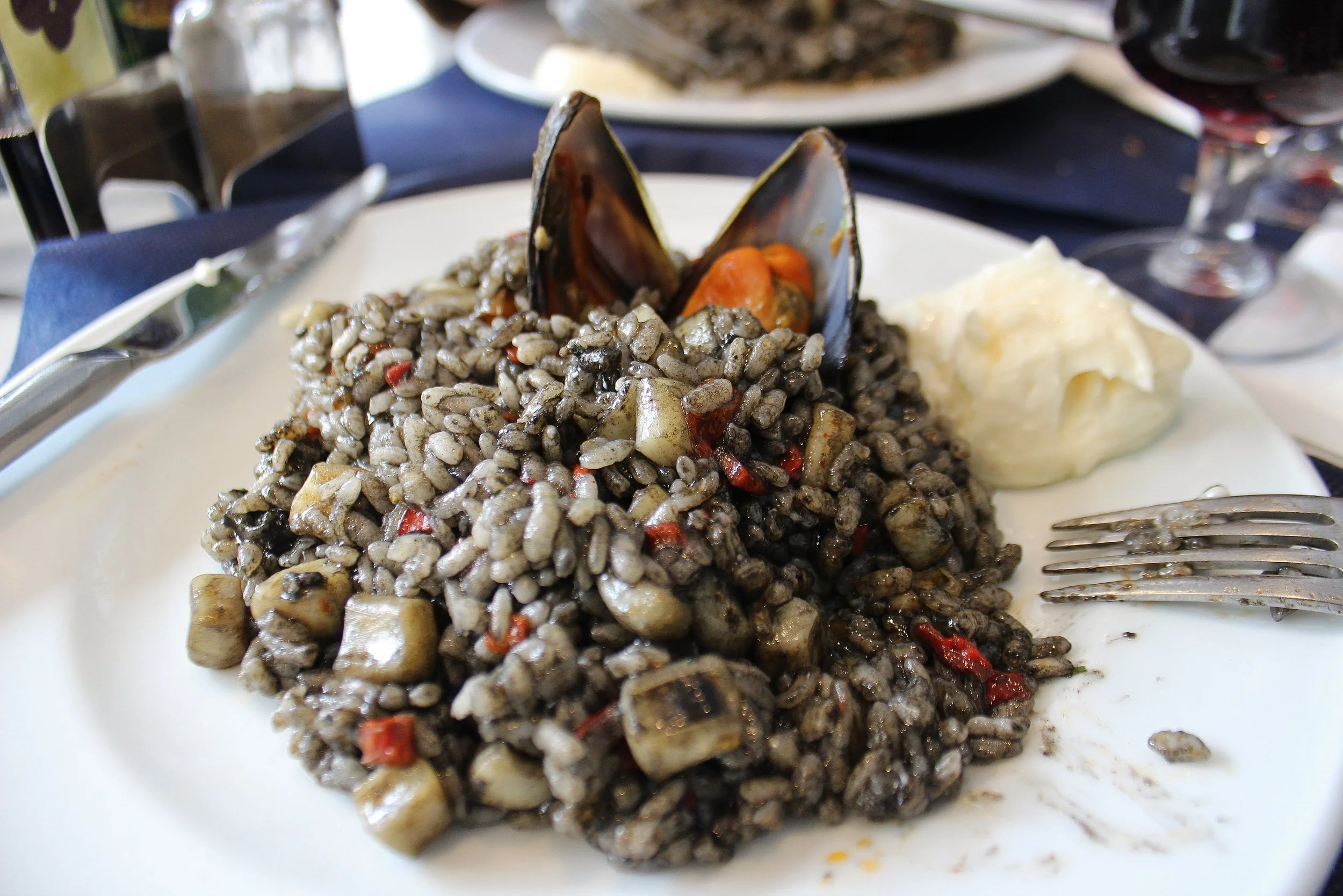 Arroz negro con mariscos. Black rice with seafood (first plate)...