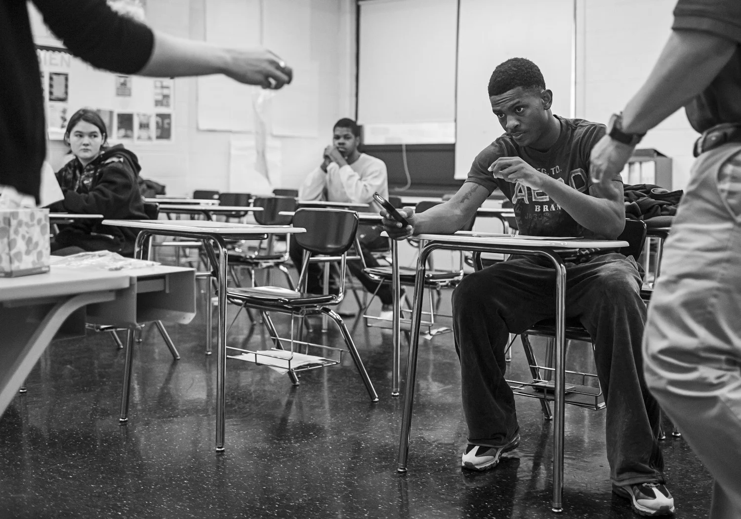 Augustin hands in his phone before his teachers begin proctoring the ACT, a standardized test measuring college readiness on a scale from 1 to 36. Augustin needs to score an 18 in order to be eligible for a basketball scholarship. On this occasion, he scored what he called a "Steve Nash," or 13, which is the number NBA player Steve Nash wore with the Phoenix Suns. He plans to take it again. 