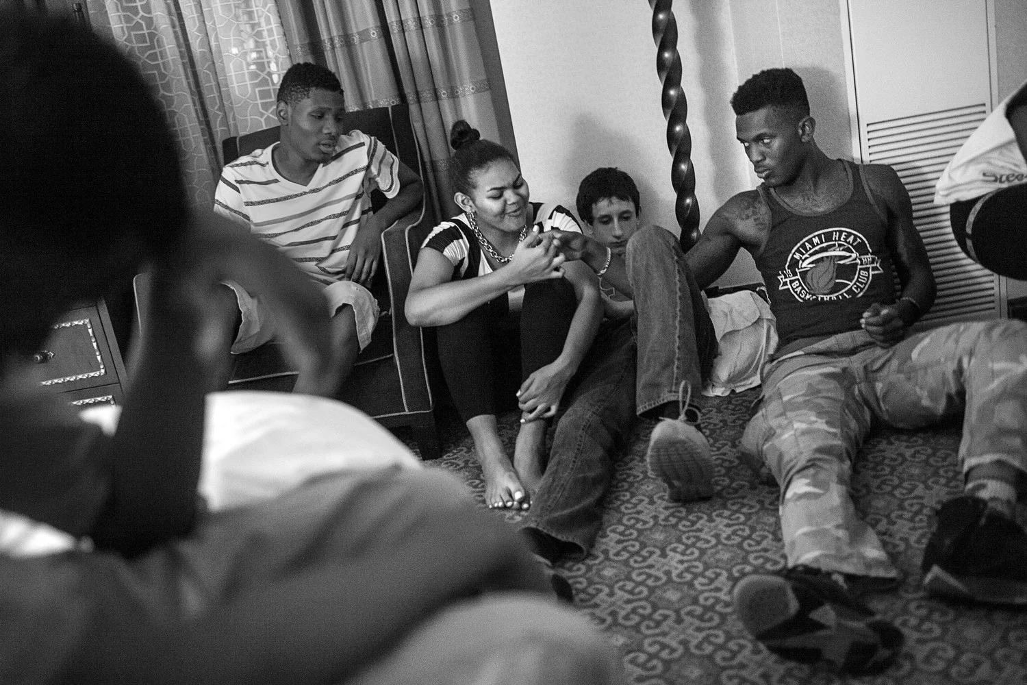 Augustin shakes hands with a friend at a Fourth of July hotel party that he co-hosted in downtown Chicago. 