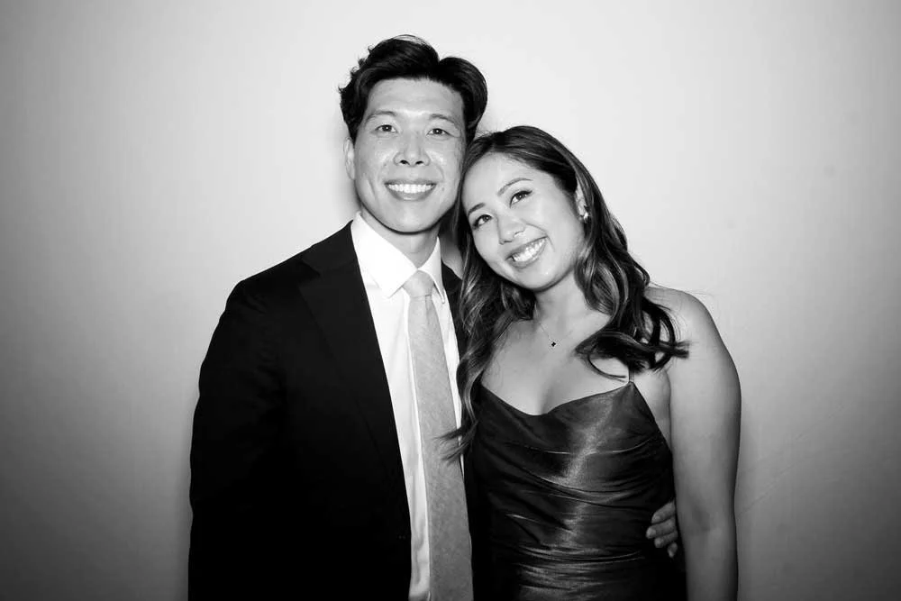 Couple in a black-and-white glam photo booth portrait at an event