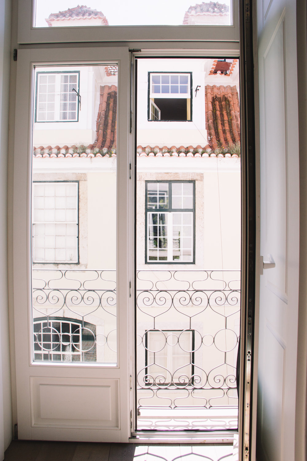 What a city dream to have french doors looking out on historic streets