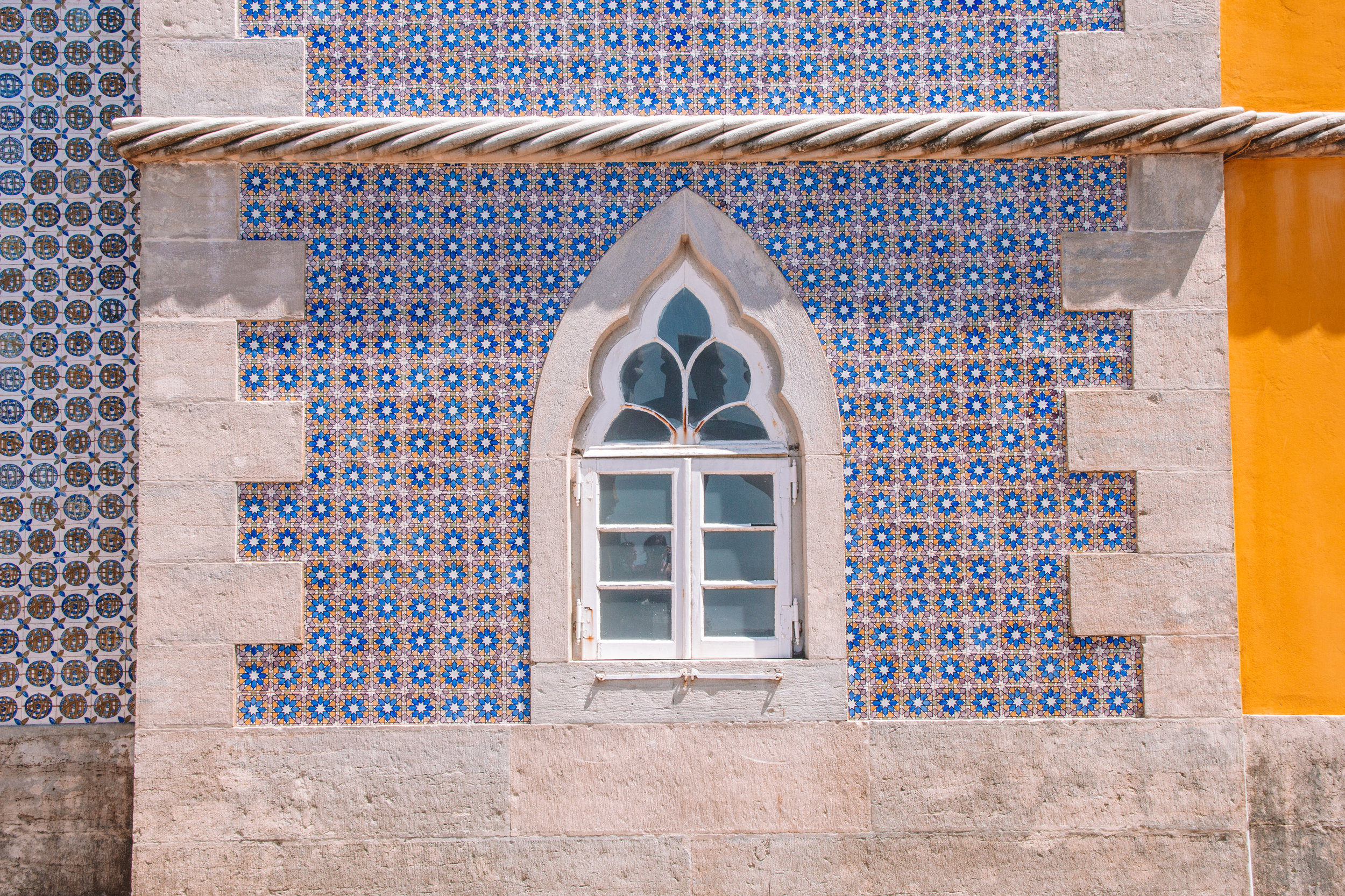 A close up of a window and blue tiled wall of Pena Palace