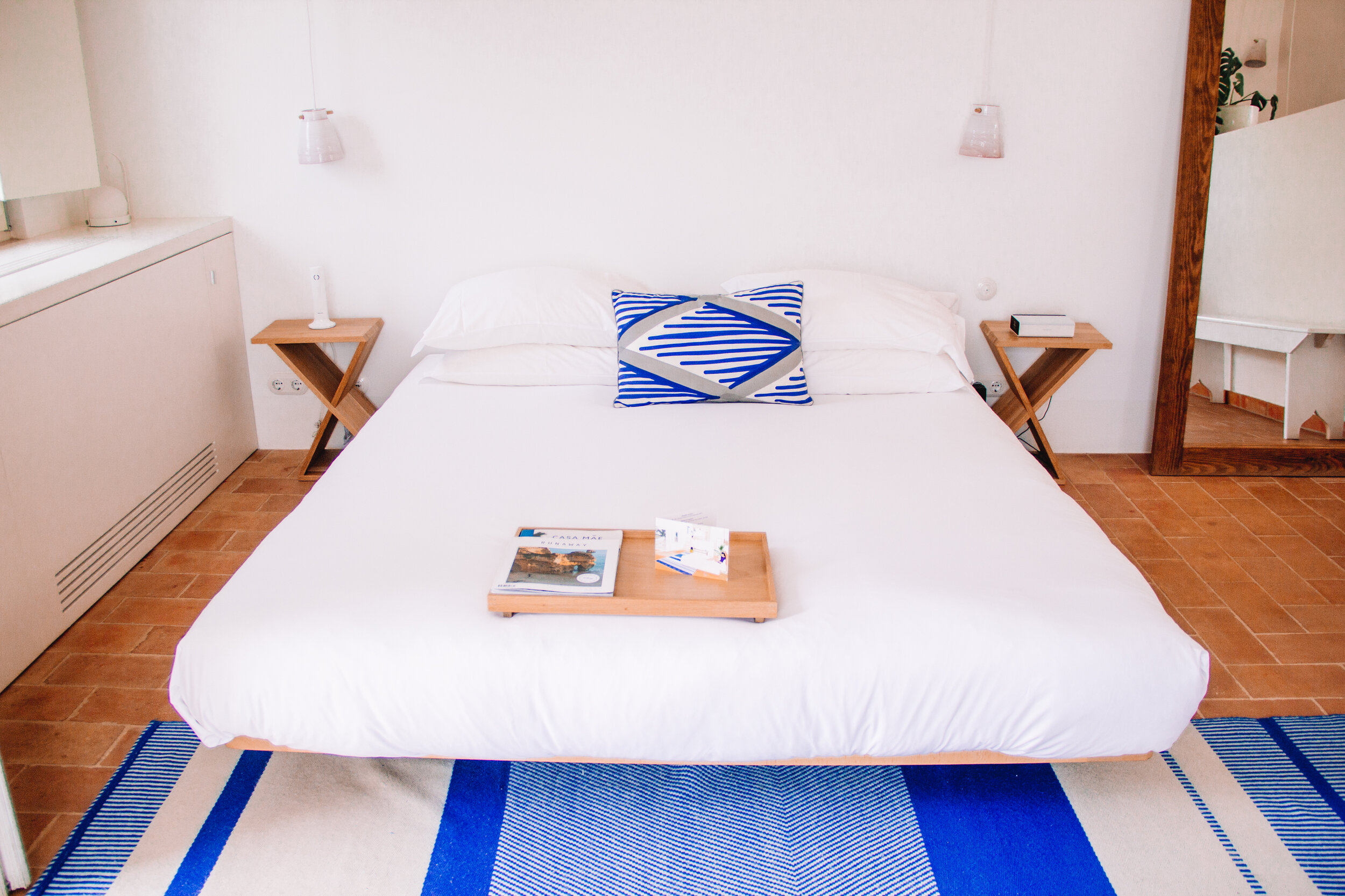 Comfortable beds with white linens at Casa Mae